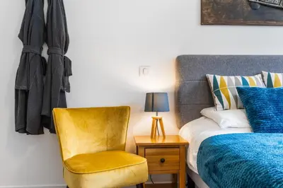 a bedroom with a bed and a chair and a lamp at Apartment Le Panoramic in Chamonix-Mont-Blanc