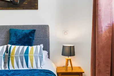 a bedroom with a bed with blue and white pillows at Apartment Le Panoramic in Chamonix-Mont-Blanc