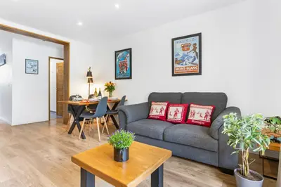 a living room with a couch and a table at Apartment Le Panoramic in Chamonix-Mont-Blanc