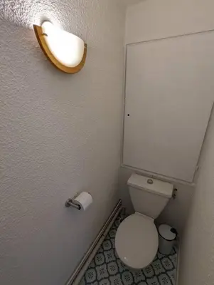 a small bathroom with a toilet and a sink at Central spacious flat with private parking in Chamonix-Mont-Blanc