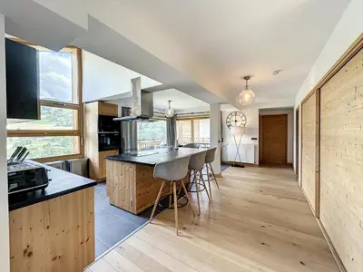a kitchen with wooden cabinets and a counter top at Chalet de Luxe 6 Chambres avec Piscine et Bien-Être à Combloux - FR-1-560-107 in Combloux