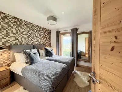 a bedroom with two beds and a mirror at Chalet de Luxe 6 Chambres avec Piscine et Bien-Être à Combloux - FR-1-560-107 in Combloux