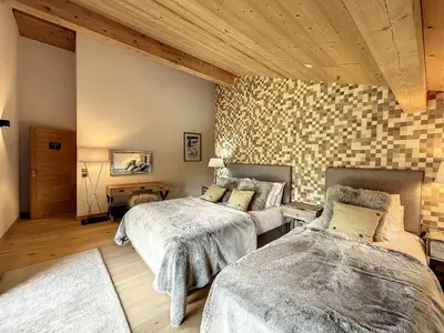a bedroom with two beds and a brick wall at Chalet de Luxe 6 Chambres avec Piscine et Bien-Être à Combloux - FR-1-560-107 in Combloux