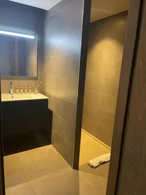 a bathroom with a sink and a mirror at Appartement standing face mont blanc piscine in Megève