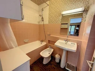 a bathroom with a sink and a toilet and a mirror at Caribou Lodge in Chamonix-Mont-Blanc