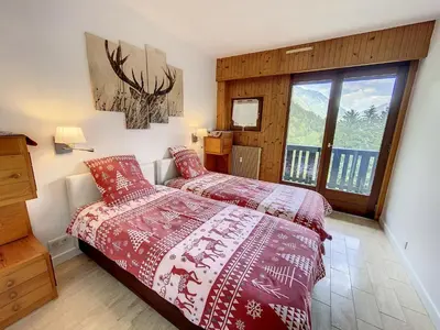 a bedroom with a bed and a large window at Caribou Lodge in Chamonix-Mont-Blanc