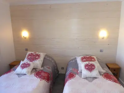 two beds in a room with hearts on them at Chalet Monte-Pente in Megève