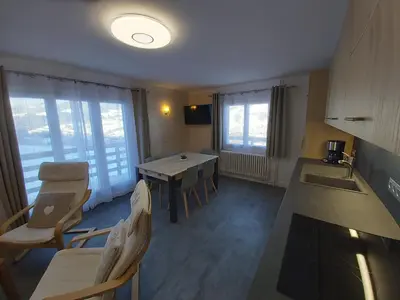 a kitchen with a table and chairs in a room at Chalet Monte-Pente in Megève