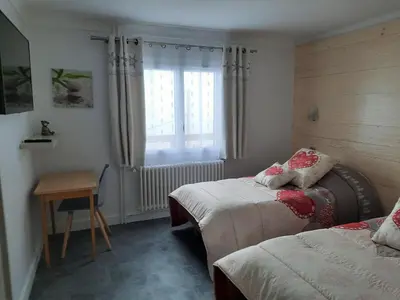 a bedroom with two beds and a window at Chalet Monte-Pente in Megève