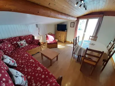 a living room with a couch and a table at Chalet Monte-Pente in Megève