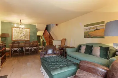 a living room with a couch and a table at Clos des vorgeats 3 - Téléphérique, Terrain de Folf, Randonnée et Bus à la porte in Chamonix-Mont-Blanc