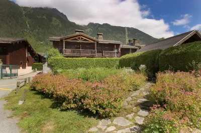 a house with a bunch of flowers in front of it at Clos des vorgeats 3 - Téléphérique, Terrain de Folf, Randonnée et Bus à la porte in Chamonix-Mont-Blanc