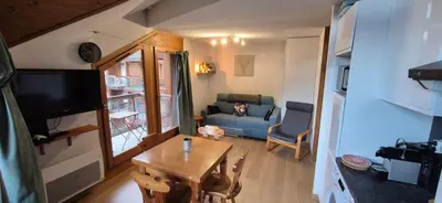 a small living room with a table and a couch at Appartement O'Contamines in Les Contamines-Montjoie