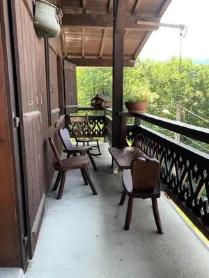 a porch with chairs and tables on a balcony at Chalet Mollaz - Mollaz 2 MAE-8074 in Saint-Gervais-les-Bains
