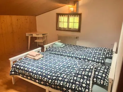 a bedroom with two beds and a table at Chalet Mollaz - Mollaz 2 MAE-8074 in Saint-Gervais-les-Bains