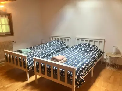 a bedroom with a bed with blue and white sheets at Chalet Mollaz - Mollaz 2 MAE-8074 in Saint-Gervais-les-Bains