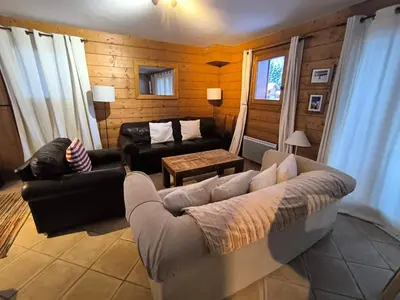 a living room with a couch and a table at Chalet Cannon- Mountain Getaway in Les Contamines-Montjoie