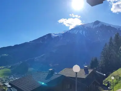 a house with a mountain in the background at Chalet Cannon- Mountain Getaway in Les Contamines-Montjoie