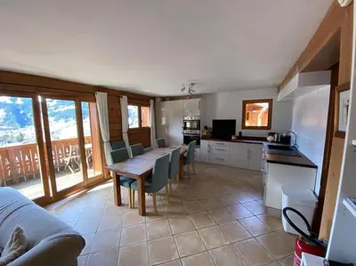 a kitchen and dining room with a table and chairs at Chalet Cannon- Mountain Getaway in Les Contamines-Montjoie