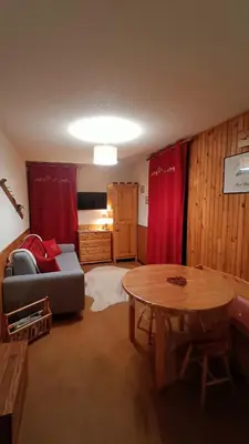 a living room with a couch and a table at Appartement pied des pistes - Samoëns 1600 in Samoëns
