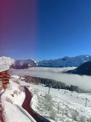 a view of a valley in the snow with a river at Appartement pied des pistes - Samoëns 1600 in Samoëns