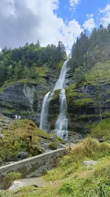 a waterfall on the side of a hill at Appartement pied des pistes - Samoëns 1600 in Samoëns