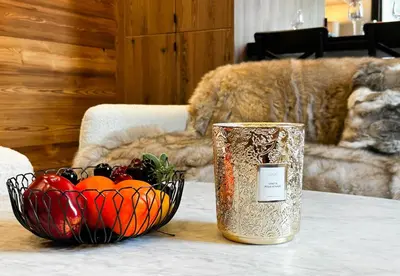 a bowl of fruit and a vase on a table at Masai Megeve in Megève