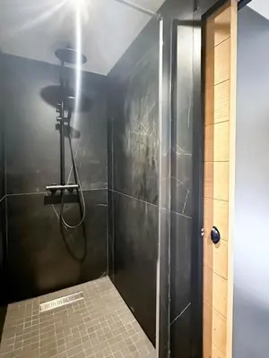 a bathroom with a shower with a glass door at Masai Megeve in Megève
