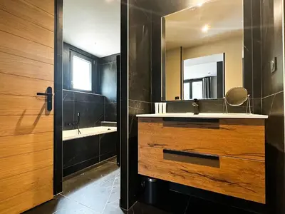 a bathroom with a sink and a mirror at Masai Megeve in Megève