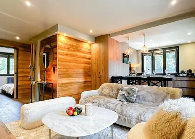 a living room with a couch and a table at Masai Megeve in Megève