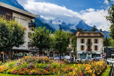 a street in a town with mountains in the background at Apartment Bonatti 201 in Chamonix-Mont-Blanc