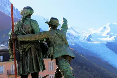 a statue of two people looking out over a mountain at Apartment Bonatti 201 in Chamonix-Mont-Blanc