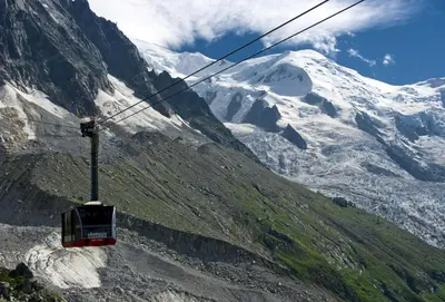 a gondola flying over a snow covered mountain at Apartment Bonatti 201 in Chamonix-Mont-Blanc