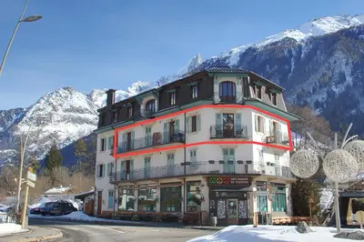 a large building in front of a mountain at Apartment Bonatti 201 in Chamonix-Mont-Blanc