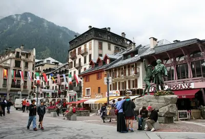 a group of people standing in a town with a statue at Apartment Bonatti 201 in Chamonix-Mont-Blanc