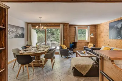 a dining room and living room with a table and chairs at Apartment Villa Vallet 1, Alpes Travel, Chamonix Old Town, Sleeps 6 in Chamonix-Mont-Blanc