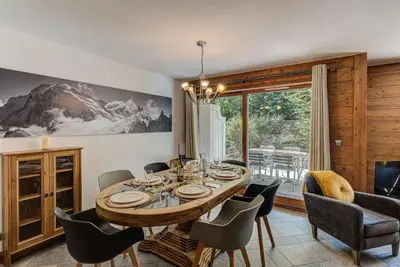 a dining room with a wooden table and chairs at Apartment Villa Vallet 1, Alpes Travel, Chamonix Old Town, Sleeps 6 in Chamonix-Mont-Blanc