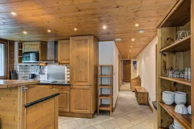 a kitchen with wooden cabinets and a wooden ceiling at Apartment Villa Vallet 1, Alpes Travel, Chamonix Old Town, Sleeps 6 in Chamonix-Mont-Blanc