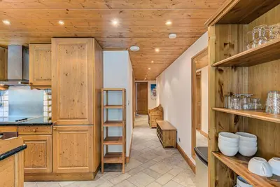a kitchen with wooden cabinets and a ladder at Apartment Villa Vallet 1, Alpes Travel, Chamonix Old Town, Sleeps 6 in Chamonix-Mont-Blanc