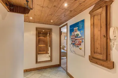 a hallway with wood ceilings and a mirror at Apartment Villa Vallet 1, Alpes Travel, Chamonix Old Town, Sleeps 6 in Chamonix-Mont-Blanc