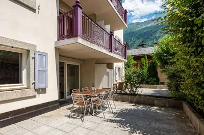 a patio with a table and chairs on a balcony at Apartment Villa Vallet 1, Alpes Travel, Chamonix Old Town, Sleeps 6 in Chamonix-Mont-Blanc