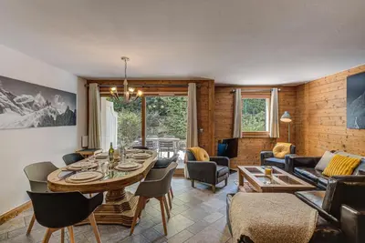 a living room with a table and a couch at Apartment Villa Vallet 1, Alpes Travel, Chamonix Old Town, Sleeps 6 in Chamonix-Mont-Blanc