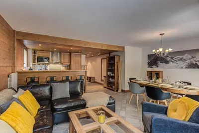 a living room with a leather couch and a table at Apartment Villa Vallet 1, Alpes Travel, Chamonix Old Town, Sleeps 6 in Chamonix-Mont-Blanc