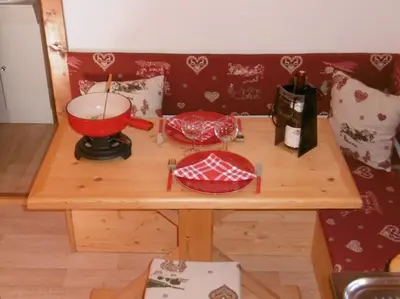 a wooden table with a red bowl and a mixer at Mazot le Petit Drus in Chamonix-Mont-Blanc