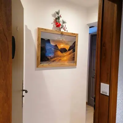 a picture hanging on a wall in a hallway at Le p'tit Rubis in Chamonix-Mont-Blanc