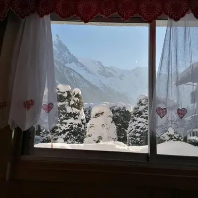 a window with a view of a snow covered mountain at Le p'tit Rubis in Chamonix-Mont-Blanc