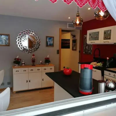 a kitchen with a table with an apple on a counter at Le p'tit Rubis in Chamonix-Mont-Blanc