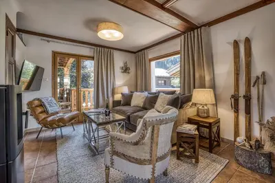 a living room with a couch and a table at Panorama du Mont-Blanc- Spacious and ideally located 1 bedroom apartment in Chamonix-Mont-Blanc