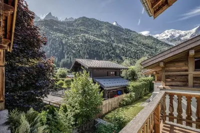 a balcony of a house with mountains in the background at Panorama du Mont-Blanc- Spacious and ideally located 1 bedroom apartment in Chamonix-Mont-Blanc