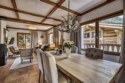 a dining room with a wooden table and chairs at Panorama du Mont-Blanc- Spacious and ideally located 1 bedroom apartment in Chamonix-Mont-Blanc